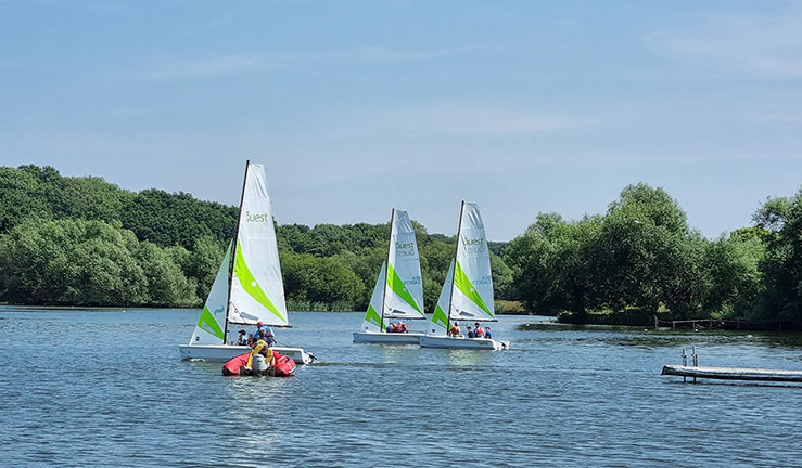 wide shot of sailing boats on a lake