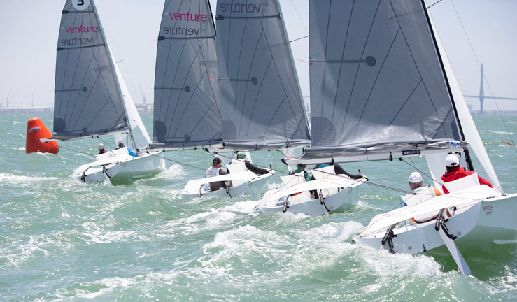 4 RS ventures racing. All boats are facing away from the camera and rounding a buoy.