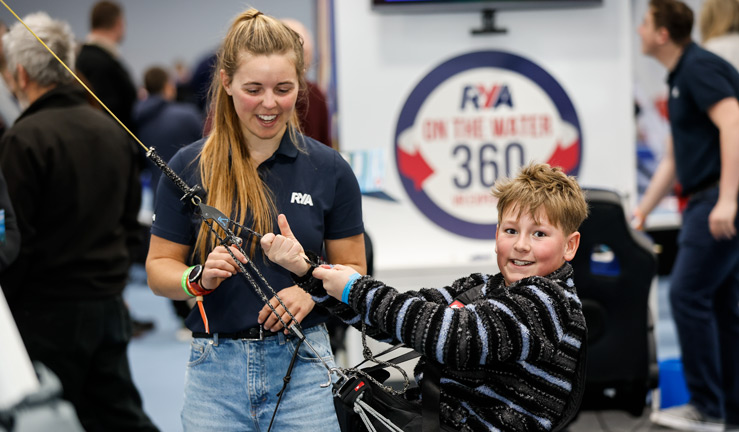 Suzuki confirmed as RYA Dinghy and Watersports Show 2023 sponsors. Boy doing trapeze rig.