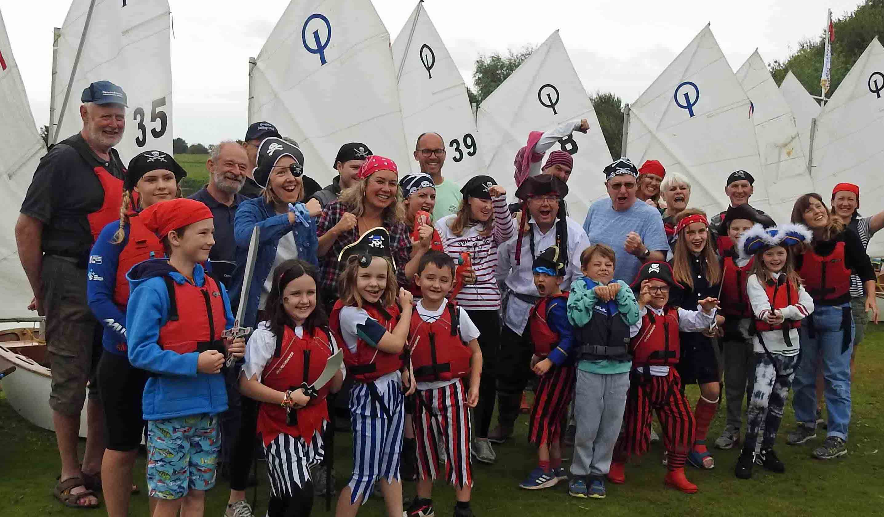 Group of young people and adults dressed as pirates.