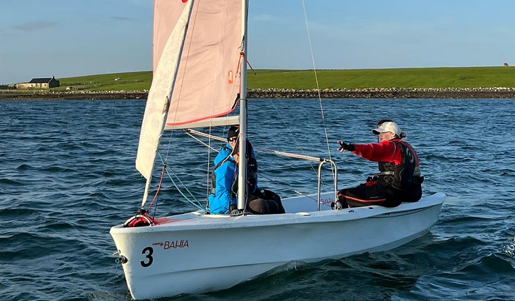 Adult learners in a Laser Bahia dinghy on Whiterock Bay, Northern Ireland