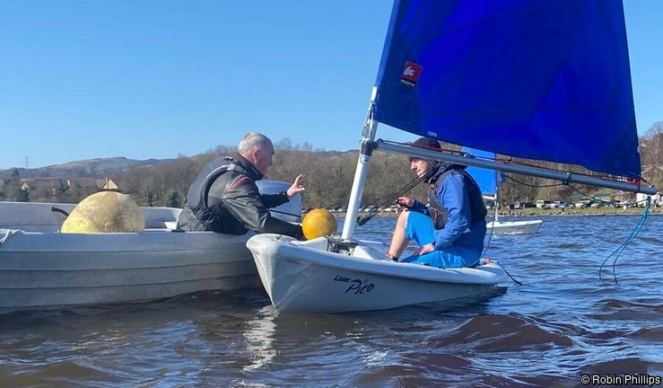 Instructor Training with a coach assessor in a safety boat and instructor in a Pico Dinghy as they brief.