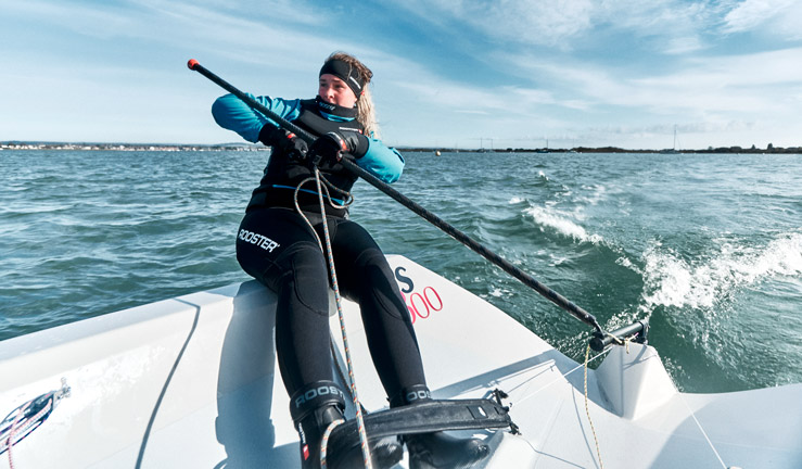 Woman in warm sailing clothes in dinghy