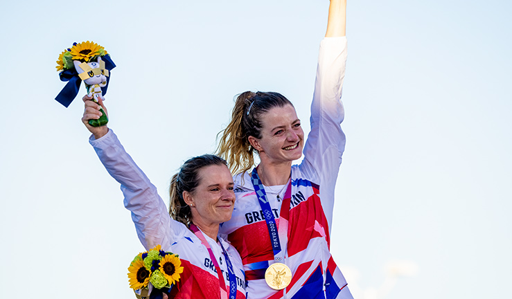 posed shot of two Olympians receiving their medals