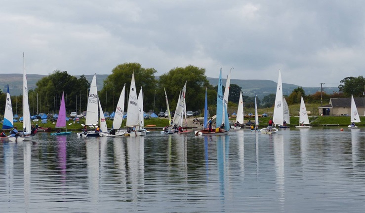 Long shot of boats sailing from harbour