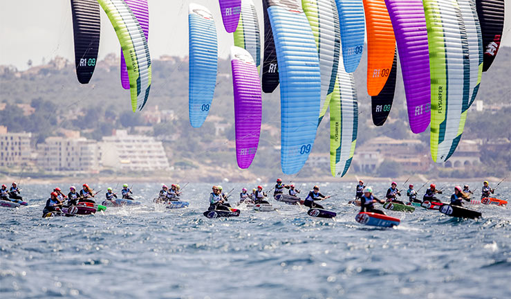 wide shot a fleet of kite surfers racing