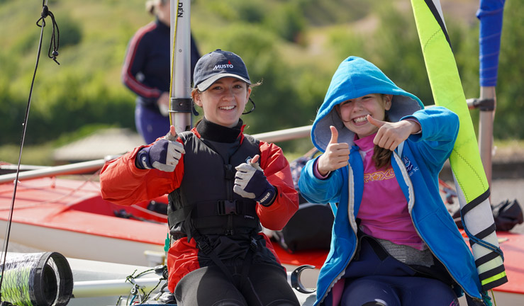 wideshot of youths on a boat