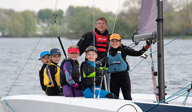 ET 2023 Championships Young sailors in a boat with instructor