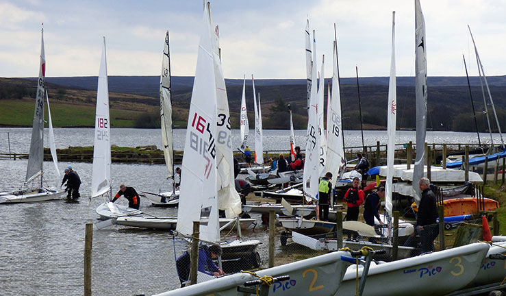 ILCA fleet preparing to launch on a grey day at Scaling Dam SC, North Yorkshire