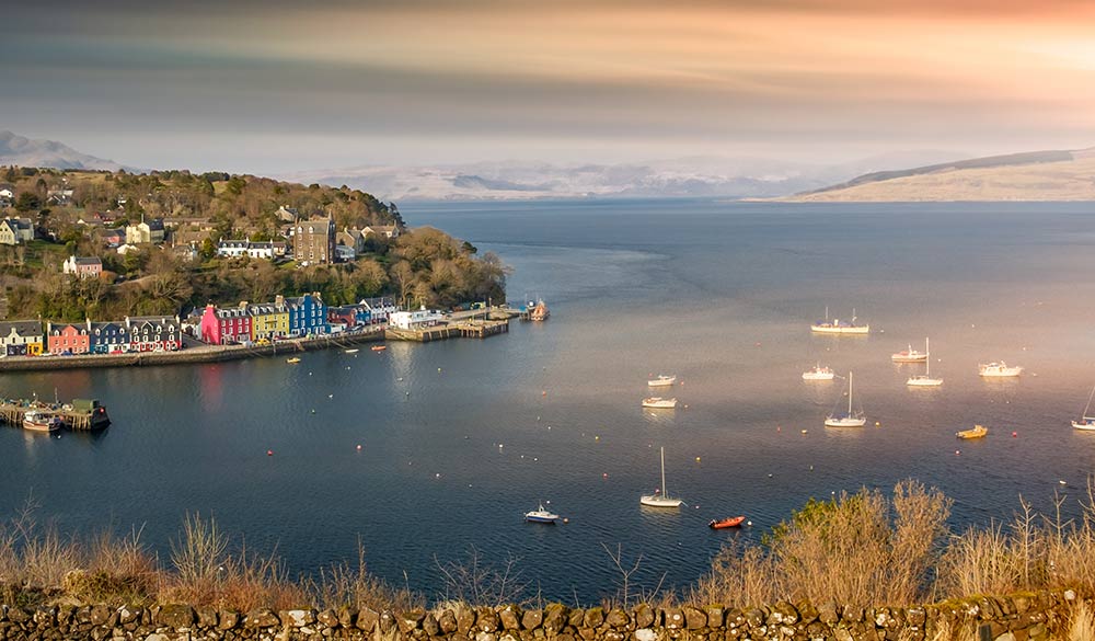 wide shot of sunrise over Tobermory Bay in Scotland