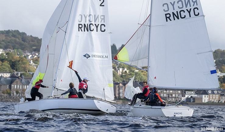 Two keelboats at Royal Northern & Clyde YC match racing downwind with the helm on one boat waving a protest flag.