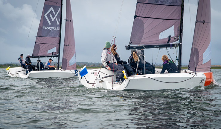Ted Blowers and Team Absolute concentrating downwind with the kite up racing an RS21 at the RYA National Match Racing Grand Finals 2023.