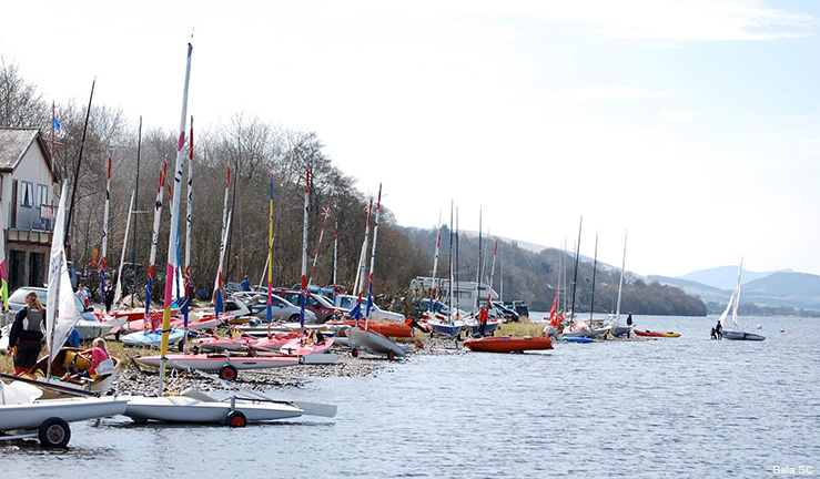 Two powerboats motoring along the shoreline in Swansea.